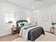Stylish bedroom with a plush rug, modern decor, and a comfortable bed with throw pillows at 16917 Clearlake Ave, Lakewood Ranch, FL 34202