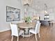 Light-filled dining space with a modern chandelier and open view to the kitchen at 16917 Clearlake Ave, Lakewood Ranch, FL 34202