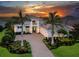 Elegant two-story home featuring a beautiful stone driveway, manicured landscaping, and a welcoming front entrance at 16917 Clearlake Ave, Lakewood Ranch, FL 34202