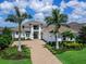 Stunning two-story home featuring lush landscaping, a three-car garage and a charming front entry at 16917 Clearlake Ave, Lakewood Ranch, FL 34202