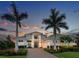 Elegant two-story home featuring a beautiful stone driveway, manicured landscaping, and a welcoming front entrance at 16917 Clearlake Ave, Lakewood Ranch, FL 34202