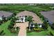 Attractive two-story home with a manicured lawn, lush landscaping, and a brick paved driveway at 16917 Clearlake Ave, Lakewood Ranch, FL 34202