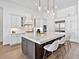 Modern kitchen featuring a spacious island with seating, stainless steel appliances, and stylish pendant lighting at 16917 Clearlake Ave, Lakewood Ranch, FL 34202