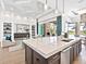 Open-concept kitchen with island, seamlessly flowing into the living area and offering views of the outdoor pool at 16917 Clearlake Ave, Lakewood Ranch, FL 34202