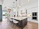Modern kitchen showcasing a large marble island, pendant lighting, and stainless steel appliances at 16917 Clearlake Ave, Lakewood Ranch, FL 34202