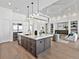 Bright kitchen with a large island, stainless steel refrigerator, and an open layout leading to the living area at 16917 Clearlake Ave, Lakewood Ranch, FL 34202