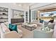 Elegant living room with stylish furnishings, custom built-ins, and seamless access to outdoor pool at 16917 Clearlake Ave, Lakewood Ranch, FL 34202