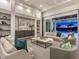 Bright living room flows out to the patio and pool, showcasing modern decor and natural light at 16917 Clearlake Ave, Lakewood Ranch, FL 34202