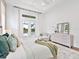 A light and bright primary bedroom featuring French doors that lead to the outdoor pool area at 16917 Clearlake Ave, Lakewood Ranch, FL 34202