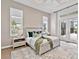 A primary bedroom with a neutral color palette, tray ceilings, and French doors leading to the pool at 16917 Clearlake Ave, Lakewood Ranch, FL 34202