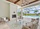 Stylish outdoor living space with fireplace offers scenic pool views and a relaxing ambiance at 16917 Clearlake Ave, Lakewood Ranch, FL 34202
