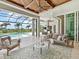 Spacious outdoor living area overlooking the pool with covered seating and outdoor kitchen at 16917 Clearlake Ave, Lakewood Ranch, FL 34202