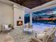 Outdoor patio features a cozy fireplace and stylish seating, perfect for enjoying the pool views at 16917 Clearlake Ave, Lakewood Ranch, FL 34202