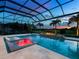 Beautiful pool with spa, gas fire feature, and colored lights at 16917 Clearlake Ave, Lakewood Ranch, FL 34202