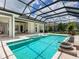 Backyard pool area featuring a jacuzzi and unobstructed views of the lush landscaping at 16917 Clearlake Ave, Lakewood Ranch, FL 34202
