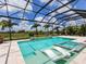 Beautiful backyard features a private pool with lounge chairs, a spa, and scenic views at 16917 Clearlake Ave, Lakewood Ranch, FL 34202