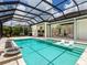 Stunning pool area showcases a hot tub, sun loungers, and a fully screened lanai at 16917 Clearlake Ave, Lakewood Ranch, FL 34202
