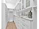 Well-organized walk-in closet featuring custom shelving, drawers, and ample storage space at 16917 Clearlake Ave, Lakewood Ranch, FL 34202