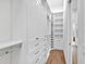 Bright walk-in closet with extensive shelving and storage options at 16917 Clearlake Ave, Lakewood Ranch, FL 34202