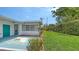 View of the backyard showcasing the home's exterior and well-maintained lawn at 2088 Grove St, Sarasota, FL 34239