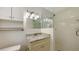 Bright bathroom featuring a glass enclosed shower, white tile and granite countertops at 2088 Grove St, Sarasota, FL 34239