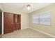 Bedroom with tile flooring, a ceiling fan, closet and a window at 2088 Grove St, Sarasota, FL 34239