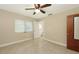 This bedroom features neutral walls, a ceiling fan, window blinds, and tile flooring at 2088 Grove St, Sarasota, FL 34239