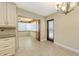 Open dining area showcasing tile flooring and an adjacent sunroom with wood accents at 2088 Grove St, Sarasota, FL 34239