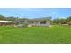 Exterior view of home showcasing its backyard, landscaping and sunroom at 2088 Grove St, Sarasota, FL 34239