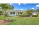 Charming home boasting a lush green lawn and beautiful, mature landscaping at 2088 Grove St, Sarasota, FL 34239