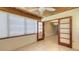 Sunroom with wood paneled ceiling, tile floors, and an opening to another room at 2088 Grove St, Sarasota, FL 34239