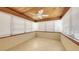 Bright sunroom with tile flooring, a wood paneled ceiling and multiple windows at 2088 Grove St, Sarasota, FL 34239