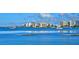 Waterfront view showcasing boats on the water with cityscape backdrop under a partly cloudy, vibrant blue sky at 2088 Grove St, Sarasota, FL 34239