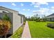 Well-maintained backyard featuring green lawn and landscaping at 2181 Harbourside Dr # 1403, Longboat Key, FL 34228
