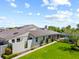 Back exterior view showcasing a green lawn and a screened-in pool area at 2181 Harbourside Dr # 1403, Longboat Key, FL 34228