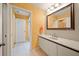 Bathroom featuring granite counter tops, large mirror, and decorative lighting at 2181 Harbourside Dr # 1403, Longboat Key, FL 34228