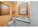 Well-lit powder room featuring framed mirrors, a stylish vanity, and fresh decor at 2181 Harbourside Dr # 1403, Longboat Key, FL 34228