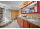 Bright bathroom features a glass shower and granite countertops with dual sinks at 2181 Harbourside Dr # 1403, Longboat Key, FL 34228