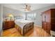 Comfortable bedroom with hardwood floors, ceiling fan, and plenty of natural light at 2181 Harbourside Dr # 1403, Longboat Key, FL 34228