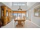 Elegant dining room with a large table, stylish chandelier, and natural light at 2181 Harbourside Dr # 1403, Longboat Key, FL 34228