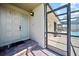 Home entrance with a brick entryway leading to a screened-in lanai with a pool at 2181 Harbourside Dr # 1403, Longboat Key, FL 34228