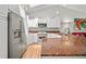 Well-lit kitchen with white cabinetry, stainless steel appliances, and spacious granite countertops at 2181 Harbourside Dr # 1403, Longboat Key, FL 34228