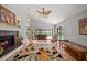 Cozy living room with hardwood floors, a fireplace, and a view of the pool area at 2181 Harbourside Dr # 1403, Longboat Key, FL 34228