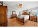 Comfortable main bedroom with wood accents, natural light, and a ceiling fan at 2181 Harbourside Dr # 1403, Longboat Key, FL 34228