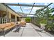 Spacious screened patio with comfortable seating and lush landscaping creating a relaxing outdoor space at 2181 Harbourside Dr # 1403, Longboat Key, FL 34228