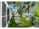 Side yard featuring manicured landscaping, a white fence, and ample green space at 2189 Hillview St, Sarasota, FL 34239