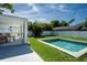 Landscaped backyard with a pool, patio, and screened-in dining space, perfect for outdoor entertaining at 2189 Hillview St, Sarasota, FL 34239