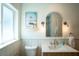 Bright bathroom features modern fixtures, a vintage vanity with art decor, plus a window view at 2189 Hillview St, Sarasota, FL 34239