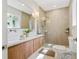 Bright bathroom features double sinks, wood cabinets, and a glass-enclosed shower at 2189 Hillview St, Sarasota, FL 34239