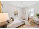 A bright bedroom features a bed and desk, with modern decor and lots of light at 2189 Hillview St, Sarasota, FL 34239